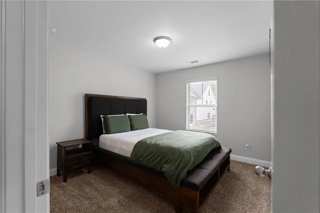 a bedroom with a bed and window