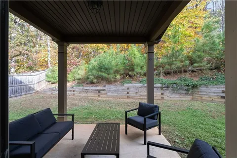 a view of a patio with a table chairs and a backyard