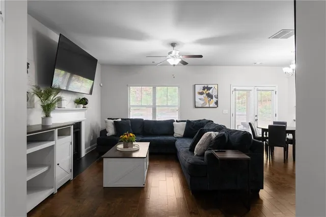 a living room with furniture fireplace and flat screen tv