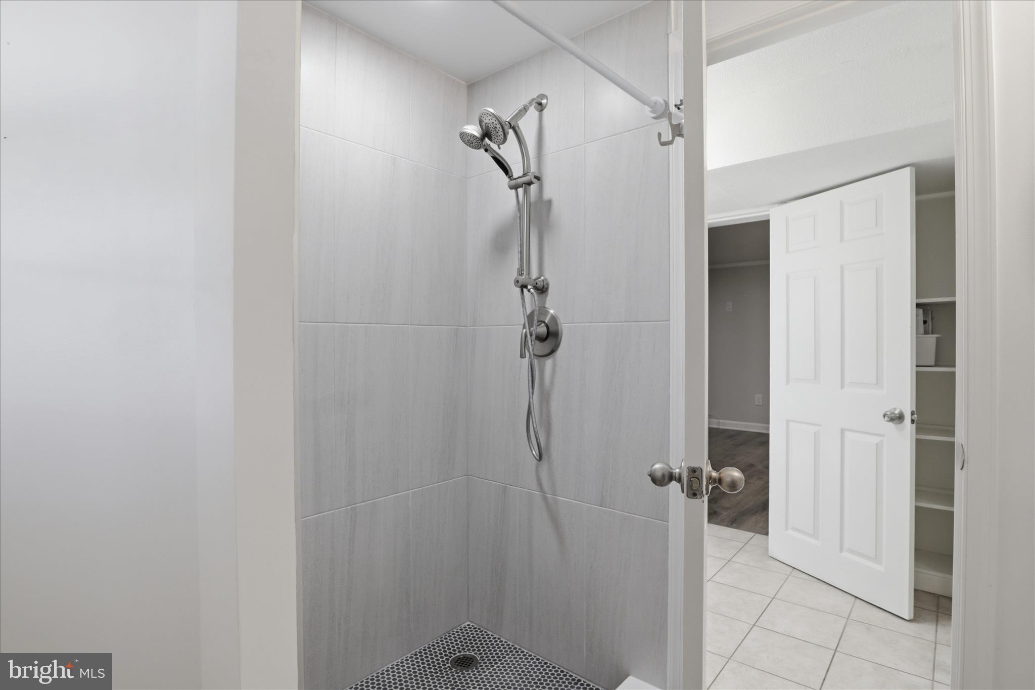 8109 Overton Court Springfield, VA 22153 - Photo 29 of 38 a bathroom with a glass shower door