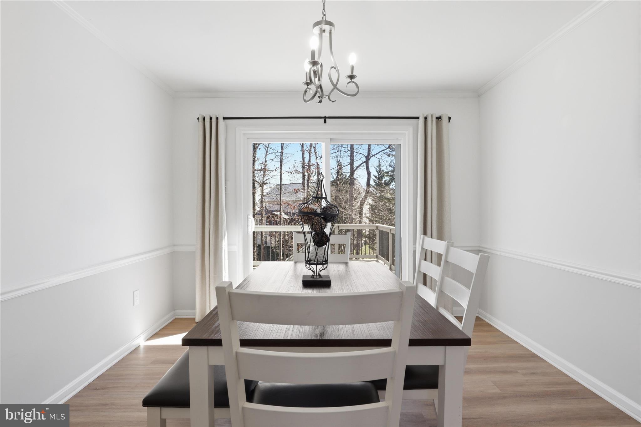 8109 Overton Court Springfield, VA 22153 - Photo 7 of 38 a dining room with wooden floor and a chandelier