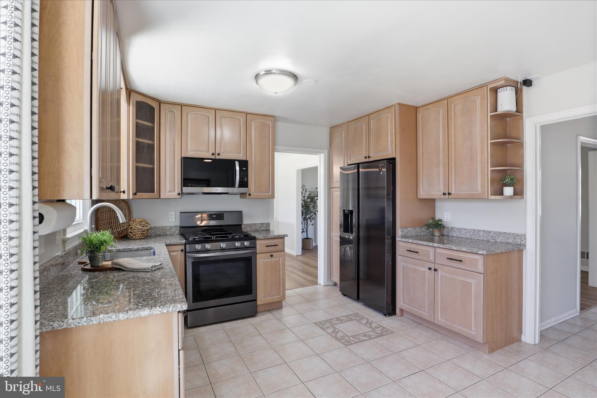 8109 Overton Court Springfield, VA 22153 - Photo 10 of 38 a kitchen with stainless steel appliances granite countertop a stove a sink and a refrigerator