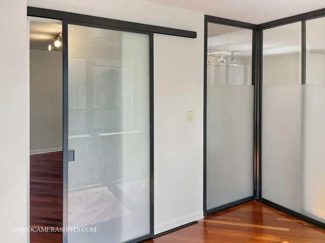 a view of empty room with wooden floor