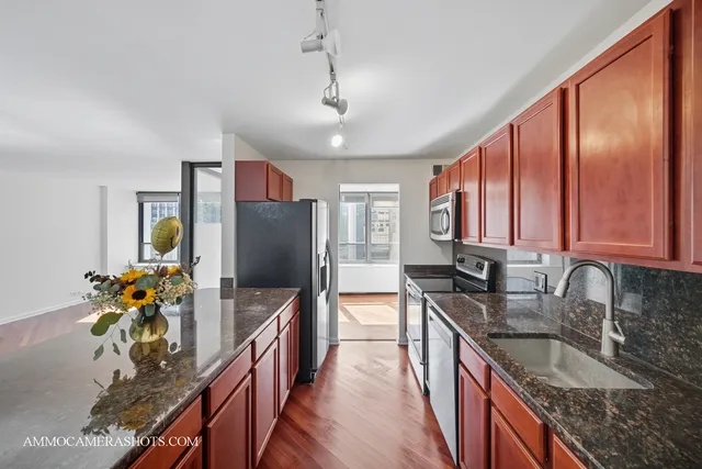 a kitchen with stainless steel appliances granite countertop a sink stove and refrigerator