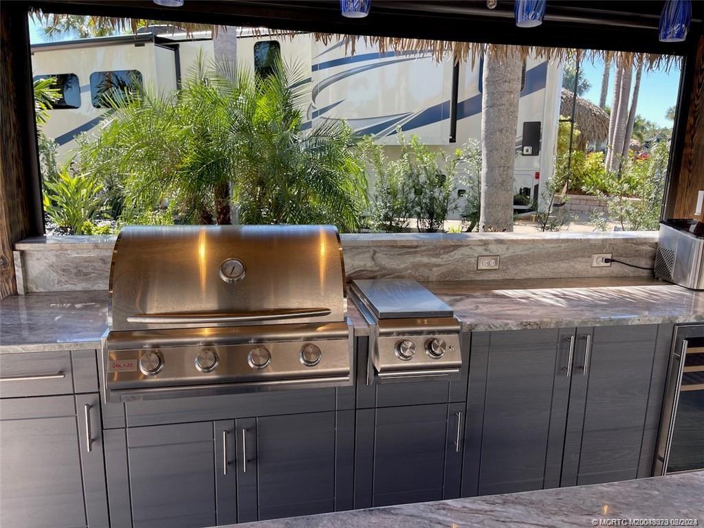 a view of barbeque grill with granite counter top