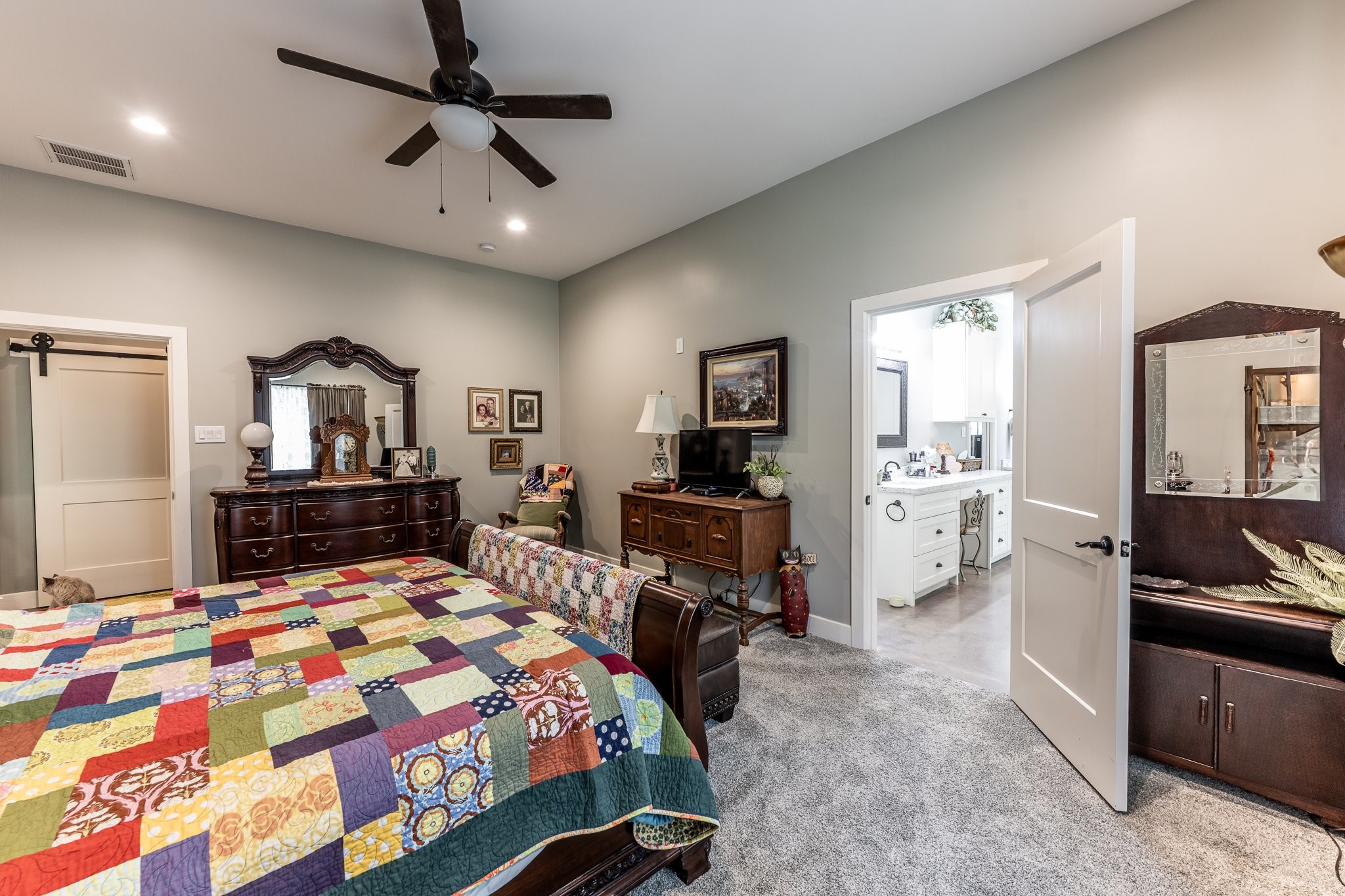 13334 Fultz Road Conroe, TX 77304 - Photo 12 of 49 The oversized primary suite offers a quiet retreat with generous space, soft finishes, and seamless access to the spa-inspired bath.