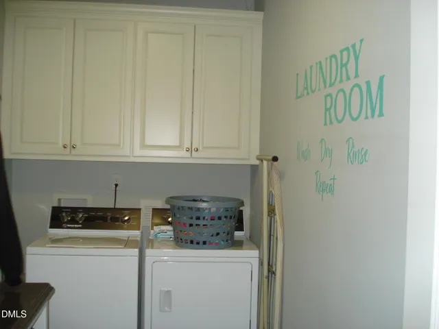a kitchen with a refrigerator and cabinets
