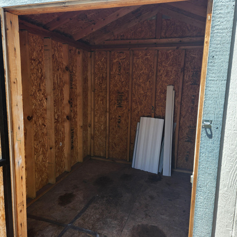 3760 Gold Ridge Drive, Unit 82 Magna, UT 84044 - Photo 7 of 29 Compact shed interior featuring oriented strand board walls and ceiling, exposed rafters, and durable wood-finish flooring
