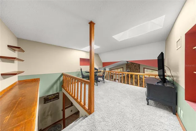 a view of a chairs and tables in the patio next to a yard