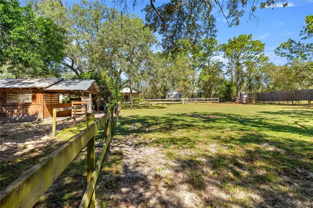 a view of a house with a yard and sitting area