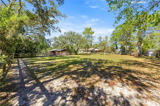 a backyard of a house with a yard and outdoor seating