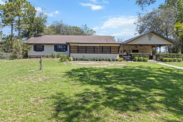 an aerial view of a house with a yard and garden