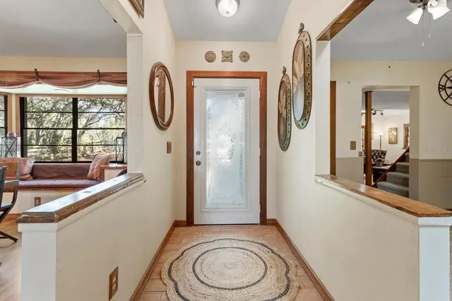 a dining room with furniture a chandelier and wooden floor