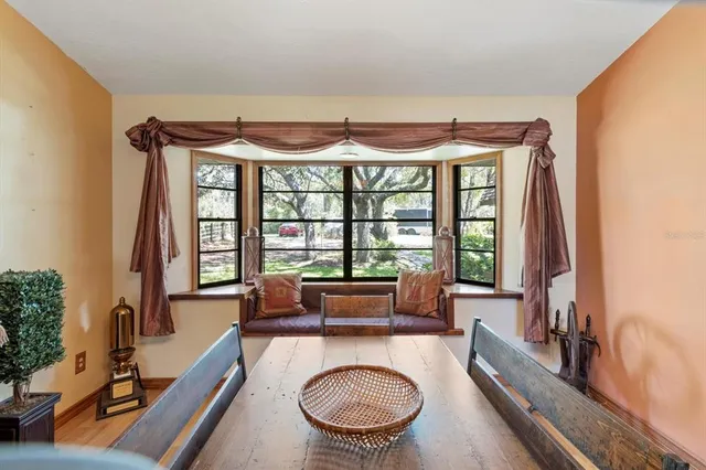 a living room with furniture a fireplace and gym equipment