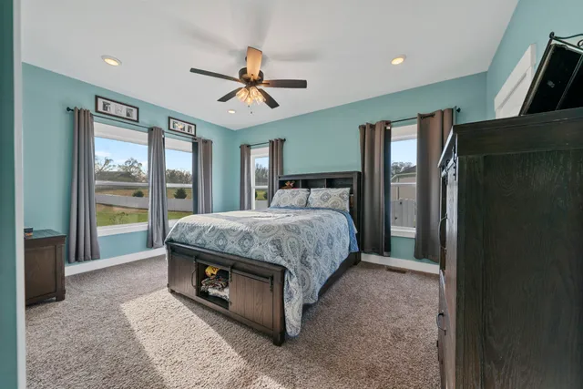 a bedroom with furniture and a chandelier