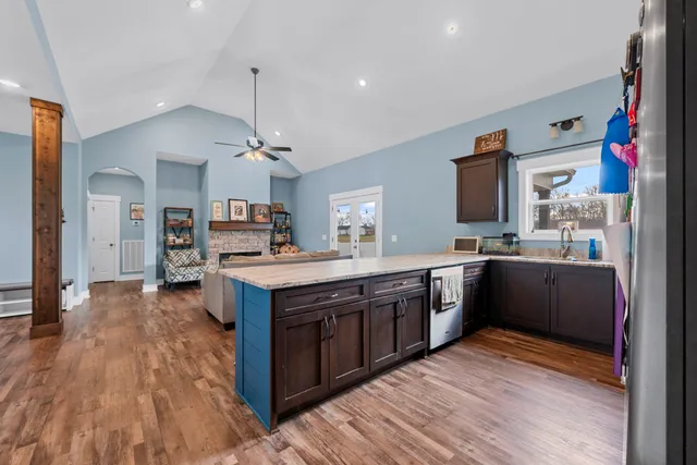 a large kitchen with stainless steel appliances and wooden cabinets