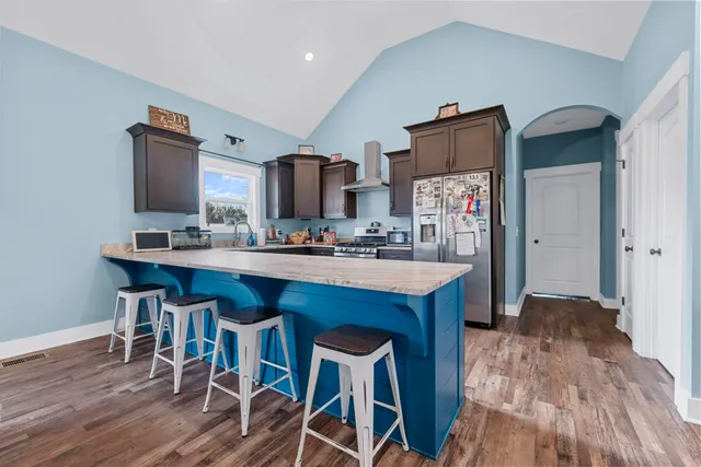 a white table sitting in a bedroom next to a window