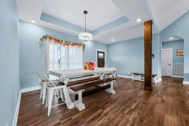 a spacious bedroom with a bed and glass door