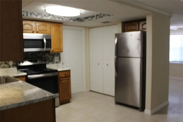 a kitchen with a refrigerator and a sink