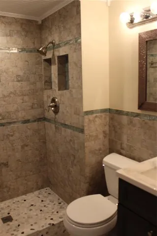 a white toilet sitting next to a bathroom sink