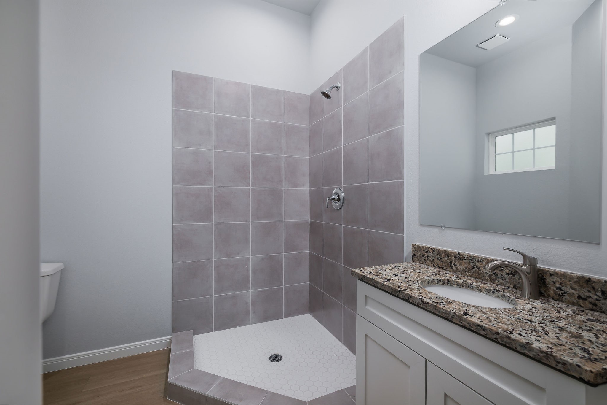 18834 Elegance Ave Spring Spring, TX 77379 - Photo 14 of 19 a bathroom with a granite countertop sink a toilet and shower