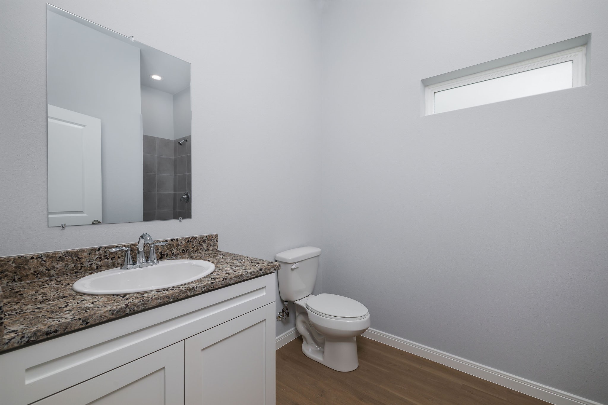 18834 Elegance Ave Spring Spring, TX 77379 - Photo 16 of 19 a bathroom with a granite countertop sink a toilet and a mirror