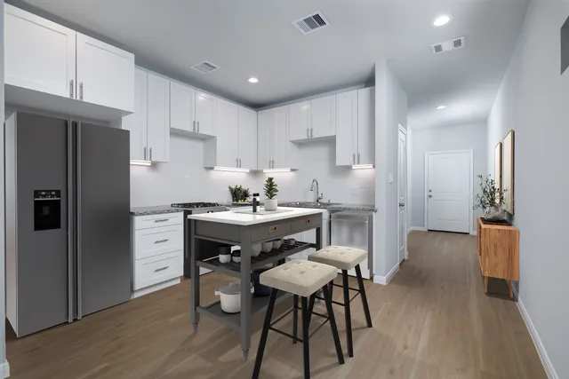 a kitchen with a refrigerator a sink and cabinets