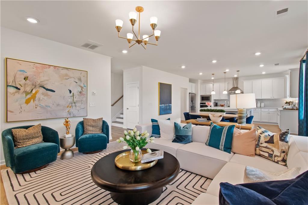 295 Abbotts Xing Circle Covington, GA 30016 - Photo 11 of 34 a living room with furniture kitchen and a chandelier