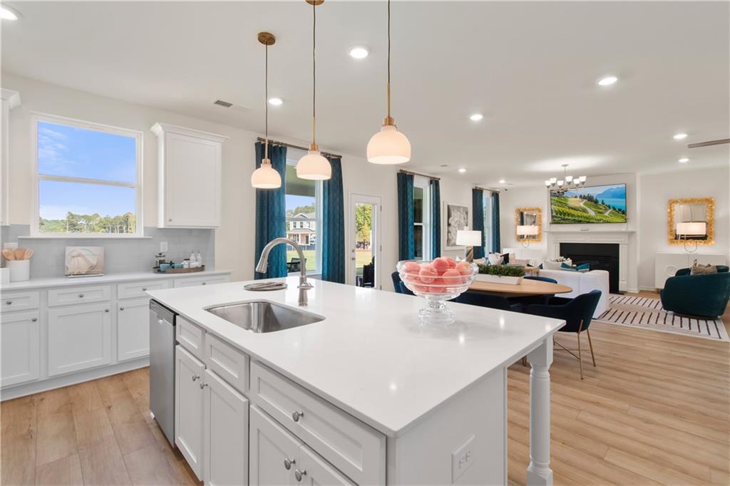 295 Abbotts Xing Circle Covington, GA 30016 - Photo 18 of 34 a large kitchen with kitchen island a large island in it