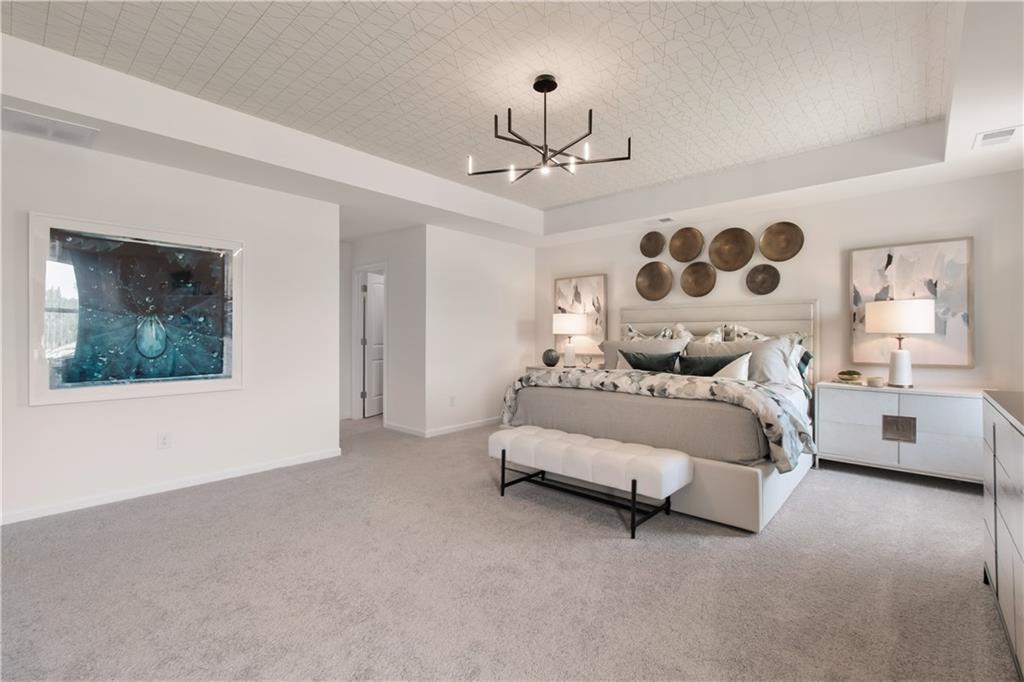 295 Abbotts Xing Circle Covington, GA 30016 - Photo 34 of 34 a bedroom with a bed lamp and a large window