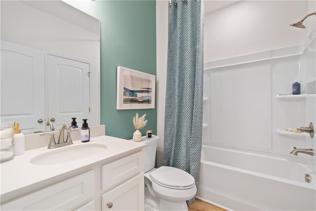 295 Abbotts Xing Circle Covington, GA 30016 - Photo 4 of 34 a bathroom with a sink toilet vanity and shower