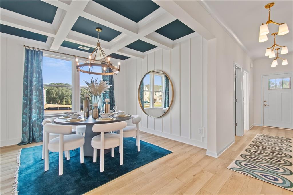 295 Abbotts Xing Circle Covington, GA 30016 - Photo 5 of 34 a dining room with wooden floor a glass table and chairs