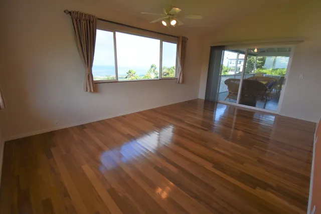 a view of a patio with table and chairs under an umbrella