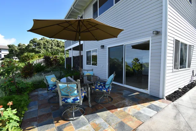 a view of a backyard with furniture and a garden