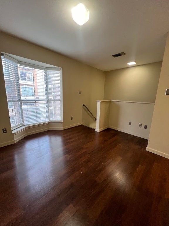 2529 Rio Grande Street, Unit 31 Austin, TX 78705 - Photo 14 of 21 an empty room with wooden floor and windows