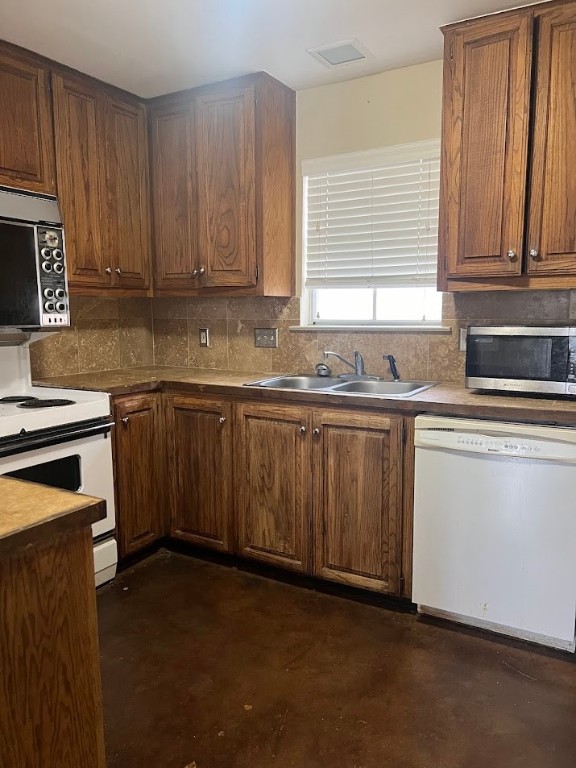 2529 Rio Grande Street, Unit 31 Austin, TX 78705 - Photo 5 of 21 a kitchen with stainless steel appliances granite countertop a sink a stove a refrigerator and cabinets