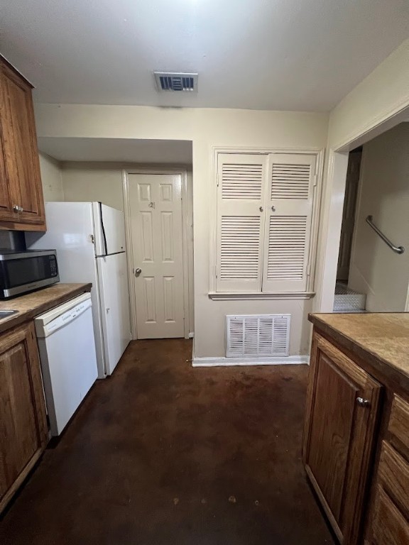 2529 Rio Grande Street, Unit 31 Austin, TX 78705 - Photo 7 of 21 a kitchen with white cabinets and a refrigerator