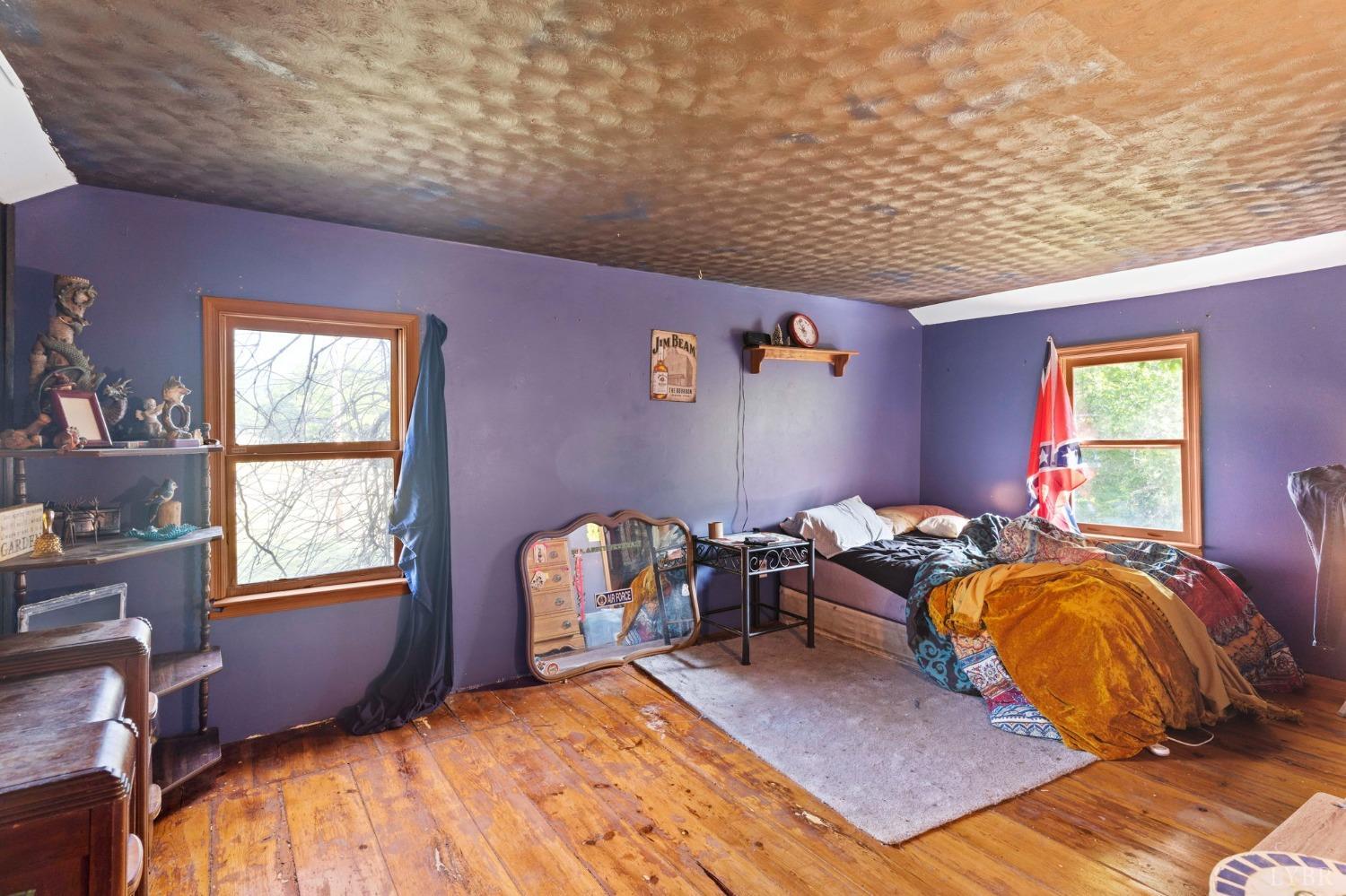 1095 Blacks Creek Road Lexington, VA 24450 - Photo 30 of 35 a bed sitting in a bedroom next to a window