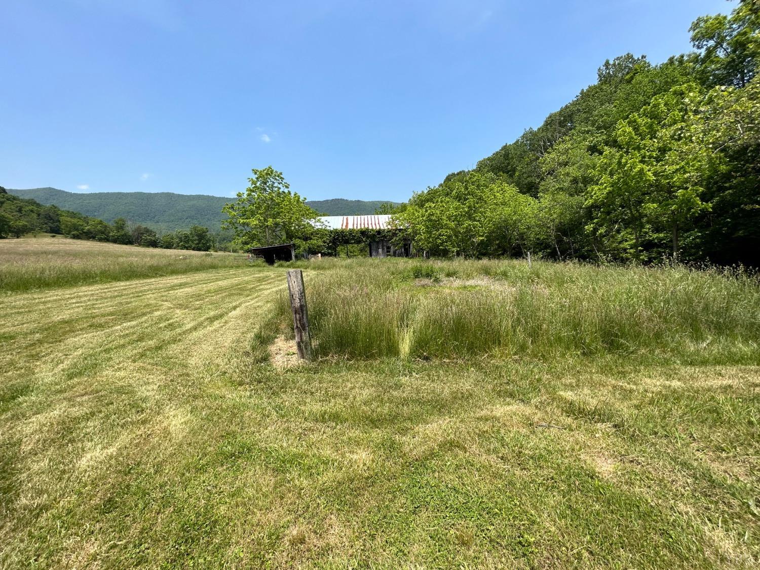 1095 Blacks Creek Road Lexington, VA 24450 - Photo 3 of 35 a view of a lake with a yard