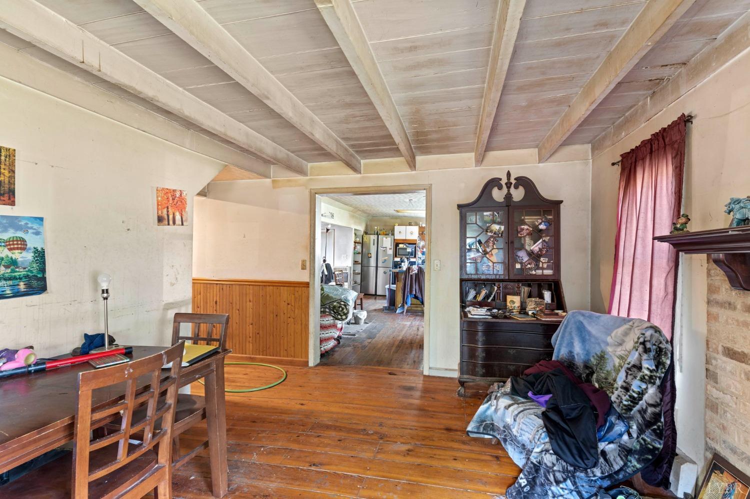 1095 Blacks Creek Road Lexington, VA 24450 - Photo 35 of 35 a living room with furniture a dining table and chairs with wooden floor