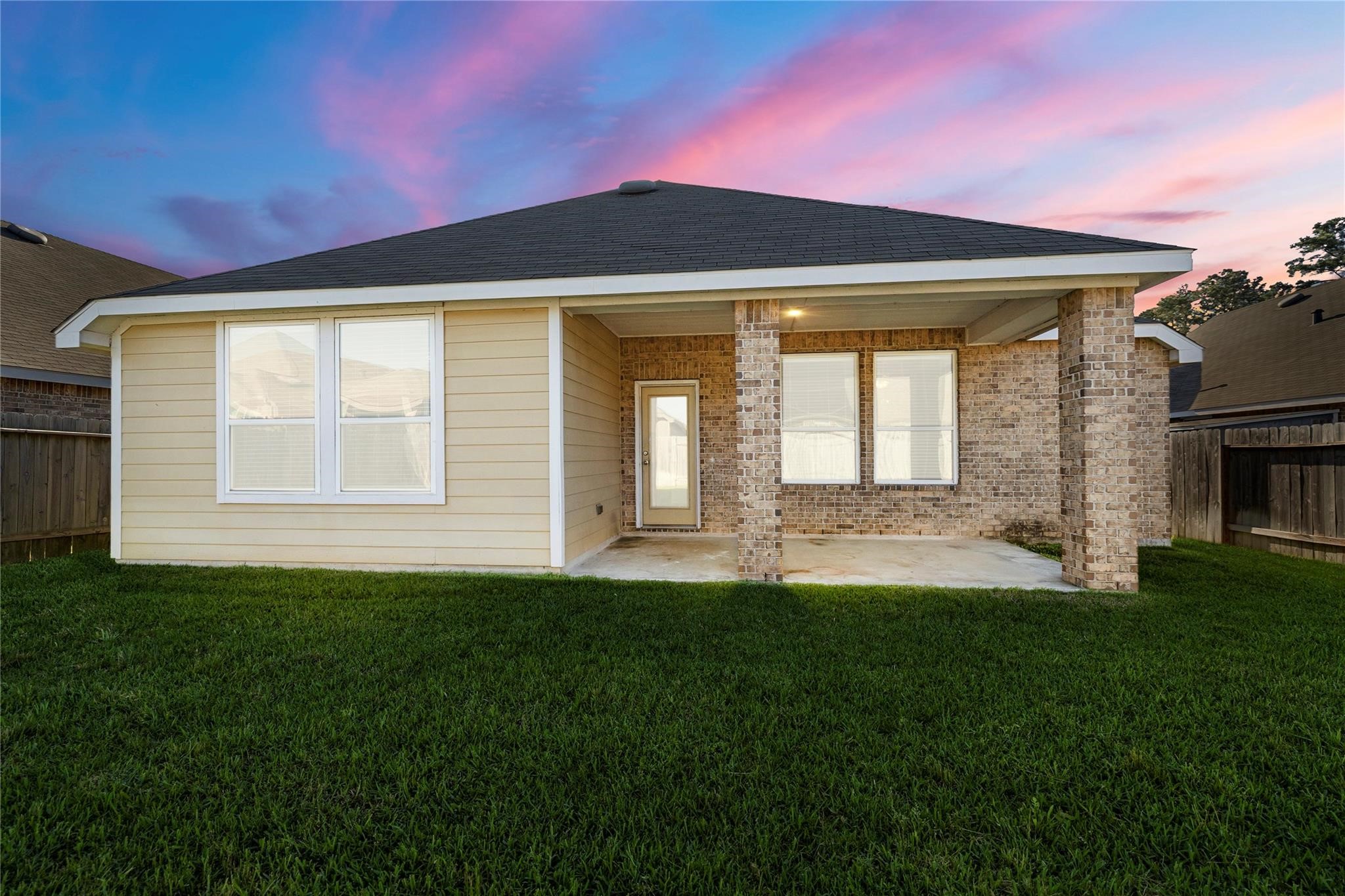 29507 Whitebrush Trace Drive Spring, TX 77386 - Photo 29 of 32 Rear exterior view with fenced backyard and covered patio.