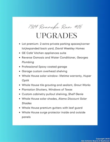 a large white kitchen with a large window appliances and cabinets