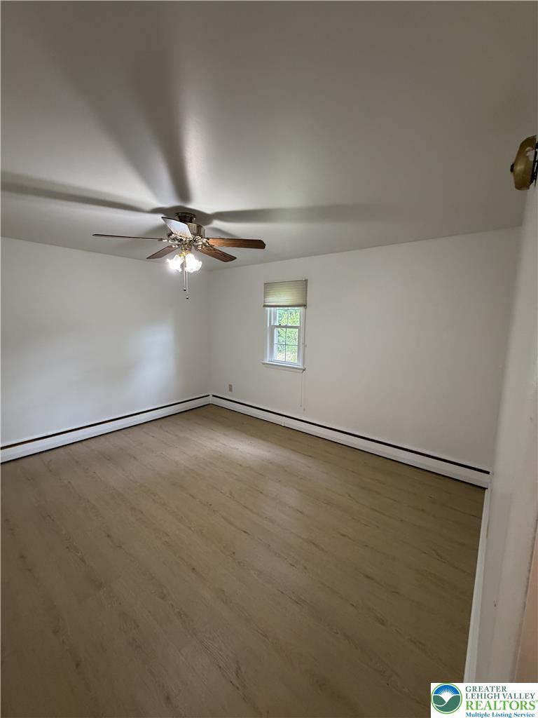 5391 Chapmans Road, Unit 2 Orefield, PA 18069 - Photo 14 of 22 Well-lit room featuring durable wood-like flooring and a convenient ceiling fan for comfort.