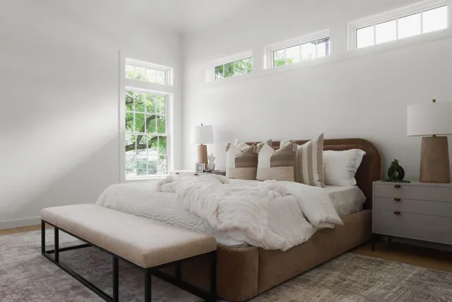 a bedroom with a bed and window