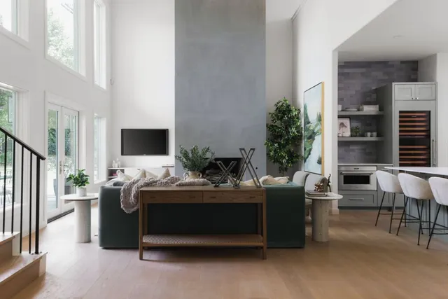 a room with a balcony a bed and a flat screen tv