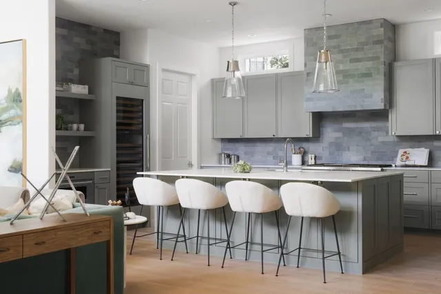 a kitchen with a table chairs sink and cabinets