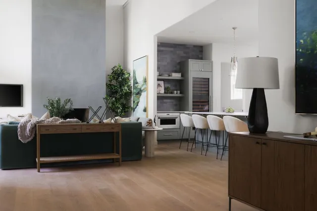 a living room with furniture a lamp and a flat screen tv