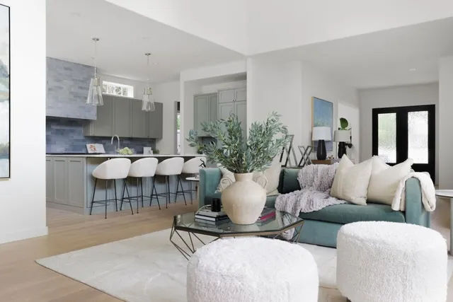 a living room with furniture a dining table and chairs