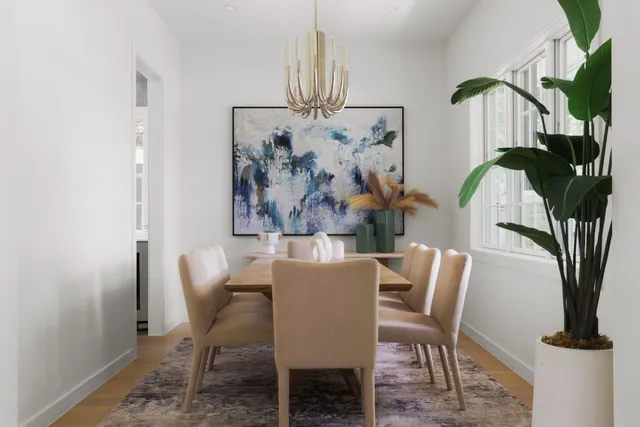 a view of a dining room with furniture and a chandelier