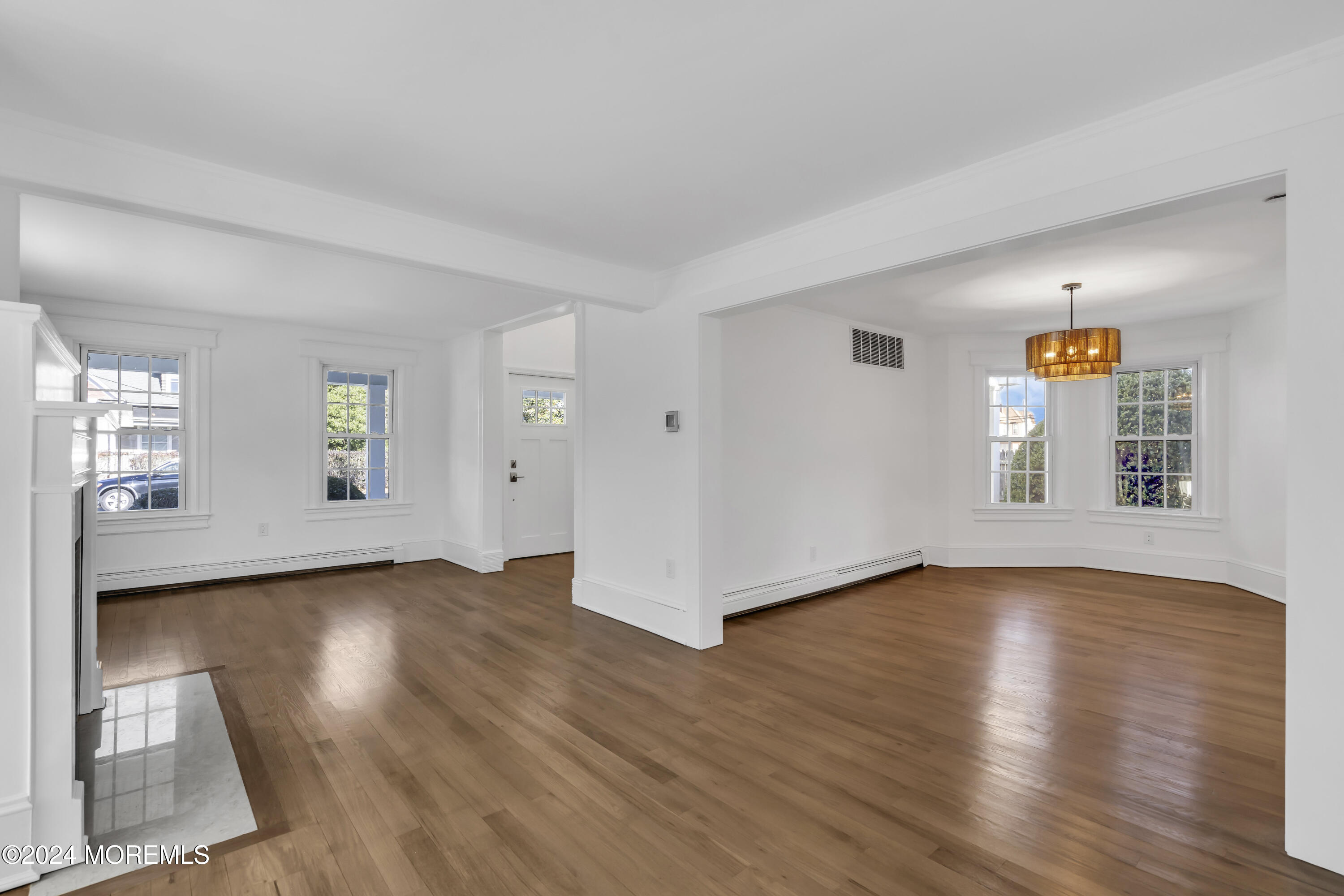 709 Prospect Avenue Spring Lake Heights, NJ 07762 - Photo 11 of 32 an empty room with wooden floor and windows